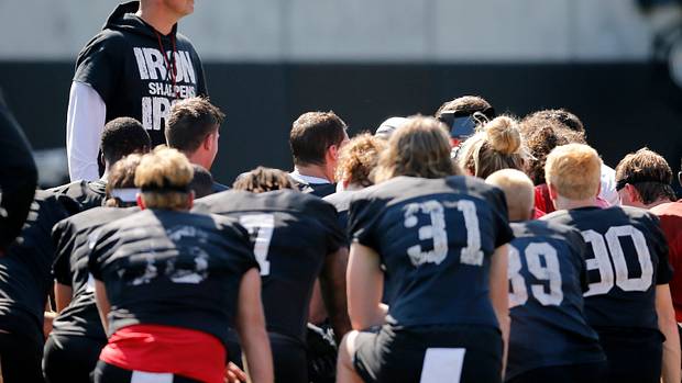 Luke Fickell speaking with his Cincinnati team during fall camp.