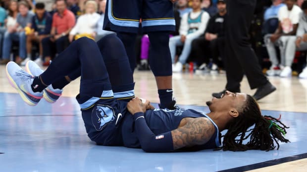 Memphis Grizzlies guard Ja Morant falls to the ground during a game.
