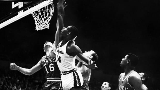 Los Angeles Lakers center Ray Felix (14) in action against St. Louis Hawks forward Cliff Hagan (16) during the 1961 playoffs at the L.A. Sports Arena.