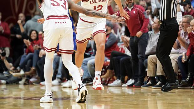 Indiana Hoosiers forward Miller Kopp (12) high-fives Indiana Hoosiers guard Tamar Bates (53) after making a three-pointer during the second half at Simon Skjodt Assembly Hall.