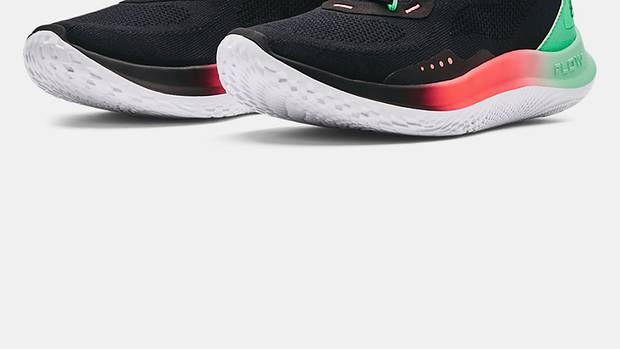 View of black, green, and red Curry Brand running shoes.