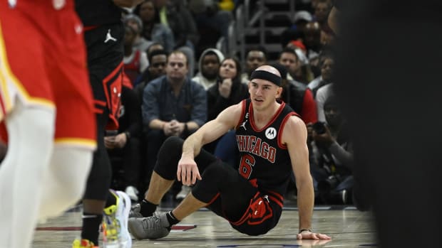 Chicago Bulls guard Alex Caruso (6) sits on the court after being knocked over against the Atlanta Hawks 