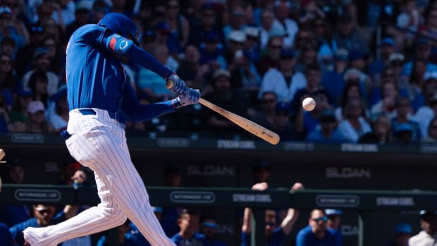 Mar 9, 2024; Mesa, Arizona, USA; Chicago Cubs outfielder Cody Bellinger (24) hits a ground-rule double on a line drive to right field to score infielder Garrett Cooper (not pictured) and infielder Nico Hoerner (not pictured) against the Colorado Rockies in the third of a spring training game at Sloan Park.