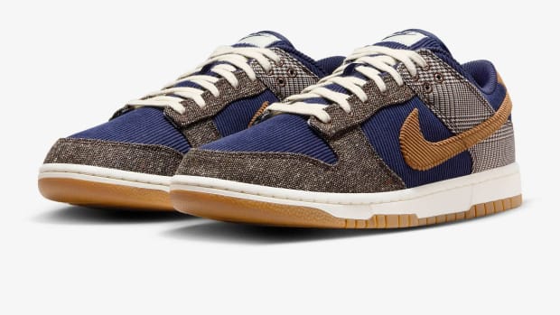 Side view of navy and brown Nike Dunk Low sneakers.