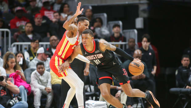 Hawks guard Dejounte Murray (5) defends Houston Rockets forward Jabari Smith Jr. (10) in the first quarter at State Farm Arena.