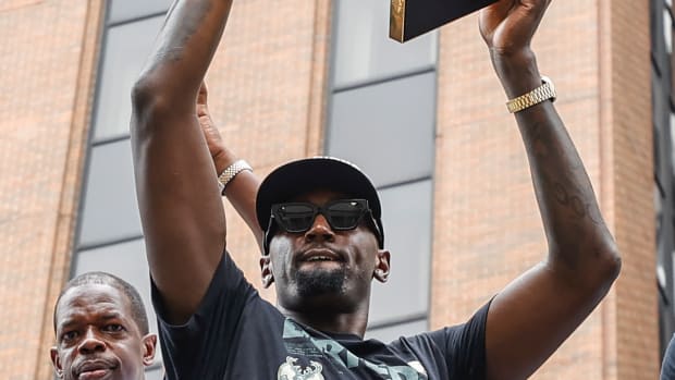 Milwaukee Bucks center Bobby Portis (9) holds the Larry O'Brien NBA Championship Trophy during the Milwaukee Bucks victory parade.