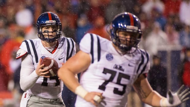 Ole Miss QB Bo Wallace wearing the now-retired white jersey with navy accents against Arkansas in 2014.
