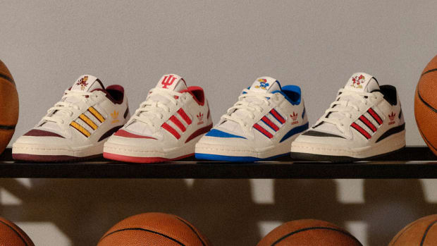 View of adidas basketball sneakers on a ball rack.