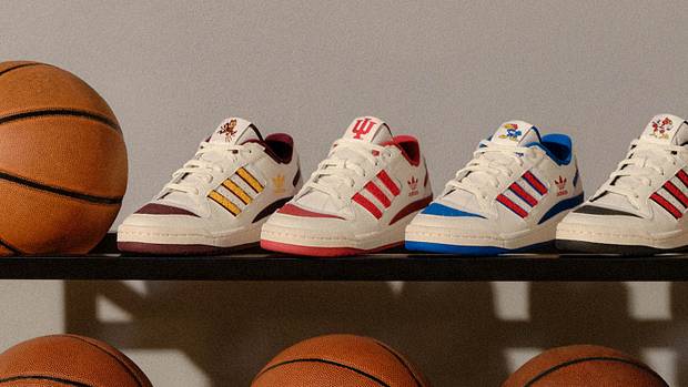 View of adidas basketball sneakers on a ball rack.