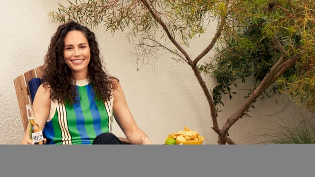 Sue Bird poses with a Corona beer in a recliner.