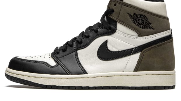 Side view of brown, white, and black Air Jordan sneaker.