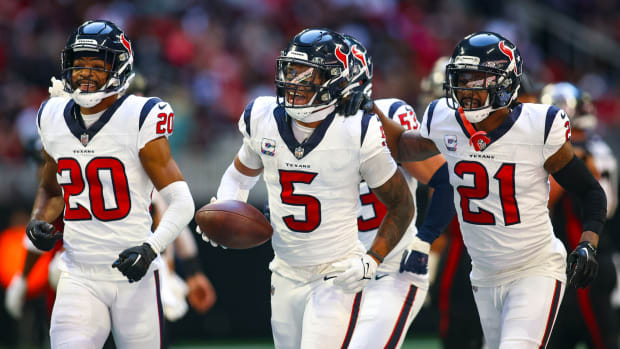 Houston Texans safety Jalen Pitre (5) celebrates with cornerback Ka'dar Hollman (20) and cornerback Steven Nelson (21) after a fumble recovery against the Atlanta Falcons in the second half at Mercedes Benz Stadium