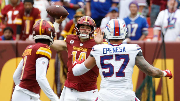 Washington Commanders quarterback Sam Howell (14) attempts to pass the ball to Commanders wide receiver Jahan Dotson (1) as Buffalo Bills defensive end AJ Epenesa (57) defends during the fourth quarter at FedExField.