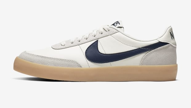 Side view of a white, navy, and tan Nike sneaker.