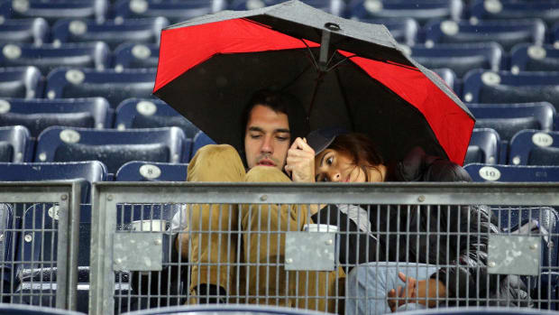 Fans wait out the rain at Yankee Stadium before Game 5 of the 2022 ALDS.