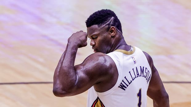 New Orleans Pelicans forward Zion Williamson flexes his arm muscles after making a shot.
