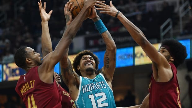 Charlotte Hornets guard Kelly Oubre Jr. (12) drives to the basket between Cleveland Cavaliers forward Evan Mobley (4) and center Jarrett Allen (31) during the first half at Rocket Mortgage FieldHouse.