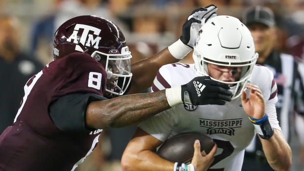 Oct 2, 2021; College Station, Texas, USA; Mississippi State Bulldogs quarterback Will Rogers (2) breaks the tackle of Texas A&M Aggies defensive lineman DeMarvin Leal (8) in the third quarter at Kyle Field.