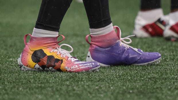 Atlanta Falcons linebacker Andre Smith's purple and pink Nike cleats.