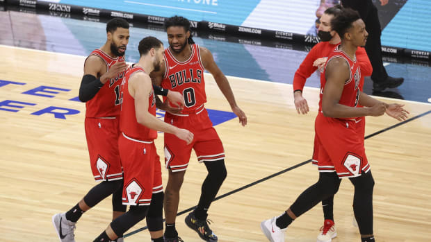Chicago Bulls guard Garrett Temple (17) and guard Zach LaVine (8) and guard Coby White (0) walk off the court during a time out