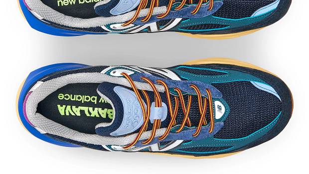 View of blue and orange New Balance shoes.
