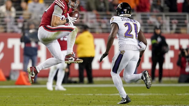 San Francisco 49ers tight end George Kittle catches a pass in front of Baltimore Ravens cornerback Brandon Stephens.