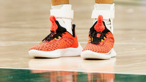 Golden State Warriors point guard Stephen Curry wearing the Sesame Street x Curry Flow 9 'Elmo'.
