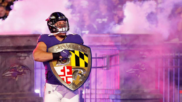 Baltimore Ravens fullback Patrick Ricard (42) carries the Ravens shield onto the field during player introductions prior to the Ravens game against the Tennessee Titans in a AFC Divisional Round playoff football game at M&T Bank Stadium.