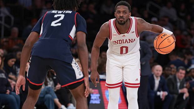 Indiana Hoosiers guard Xavier Johnson (0) dribbles in front of Connecticut Huskies guard Tristen Newton (2) during the second half at Madison Square Garden.