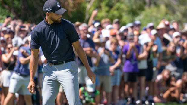 Stephen Curry celebrates on the golf course.