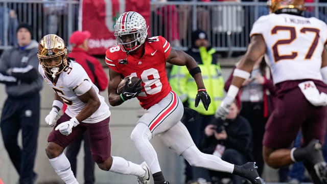 Ohio State Buckeyes wide receiver Marvin Harrison Jr. (18) runs past Minnesota Golden Gophers defensive back Justin Walley (5) after making a catch during the first half of the NCAA football game at Ohio Stadium.