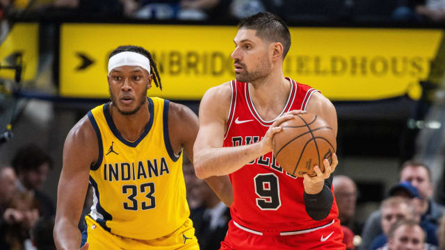  Chicago Bulls center Nikola Vucevic (9) looks to pass while Indiana Pacers center Myles Turner (33) defends in the second half at Gainbridge Fieldhouse.