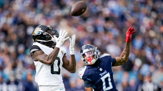 Jacksonville Jaguars wide receiver Calvin Ridley (0) receives a pass to bring in a touchdown past Tennessee Titans cornerback Sean Murphy-Bunting (0) during the second quarter at Nissan Stadium in Nashville, Tenn., Sunday, Jan. 7, 2024.