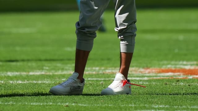 View of Miami Dolphins head coach Mike McDaniel's white Nike sneakers.