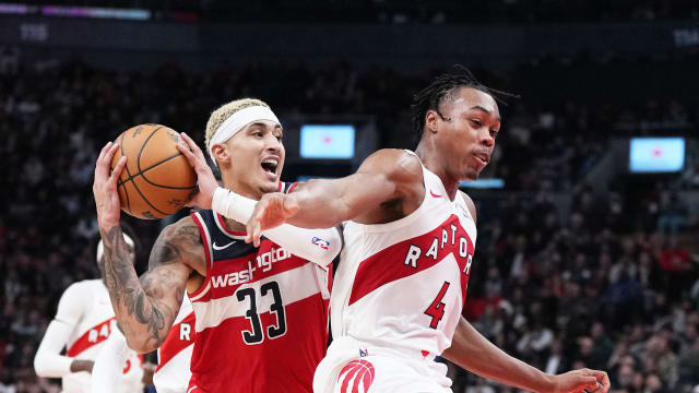 Washington Wizards forward Kyle Kuzma (33) battles for the ball with Toronto Raptors forward Scottie Barnes (4) during the fourth quarter at Scotiabank Arena. 