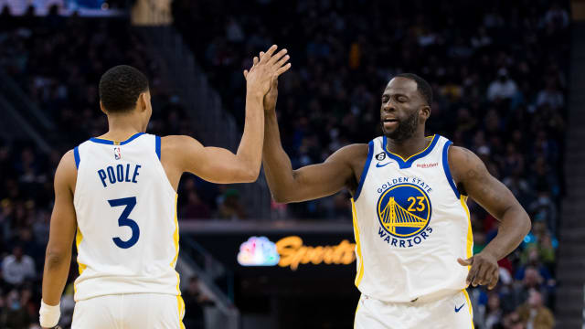 Golden State Warriors guard Jordan Poole (3) and forward Draymond Green (23) celebrate after Poole drew a foul against the Brooklyn Nets during the first half at Chase Center.