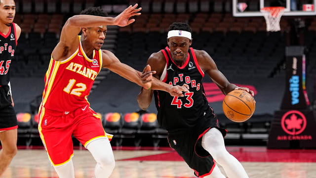 Toronto Raptors forward Pascal Siakam drives to the net against Atlanta Hawks forward De'Andre Hunter. The Hawks and Raptors play each other three times in the 2022-23 NBA season.