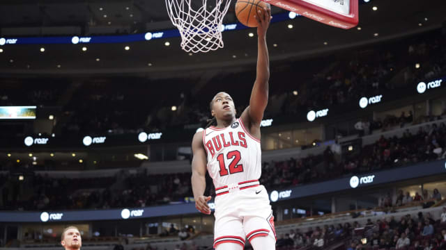  Chicago Bulls guard Ayo Dosunmu (12) scores against the Toronto Raptors during the second half at United Center.