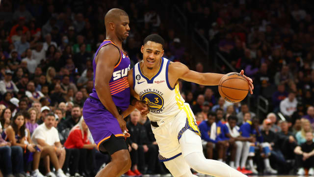 Golden State Warriors guard Jordan Poole (right) controls the ball against Phoenix Suns guard Chris Paul in the second half at Footprint Center.