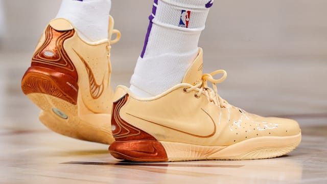 Side view of Los Angeles Lakers forward LeBron James' orange Nike sneakers.