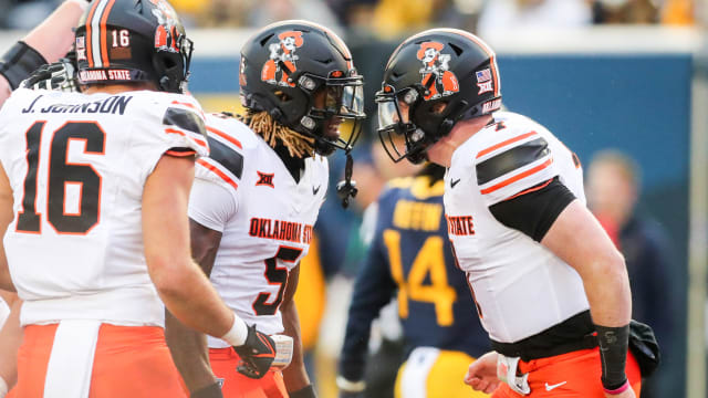 Oct 21, 2023; Morgantown, West Virginia, USA; Oklahoma State Cowboys wide receiver Jaden Bray (5) celebrates with Oklahoma State Cowboys quarterback Alan Bowman (7) after connecting for a touchdown during the third quarter against the West Virginia Mountaineers at Mountaineer Field at Milan Puskar Stadium. Mandatory Credit: Ben Queen-USA TODAY Sports