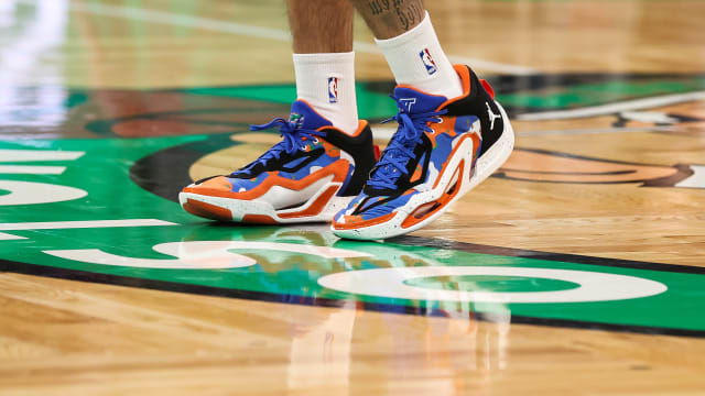 Boston Celtics forward Jayson Tatum's blue and orange Jordan Brand sneakers.