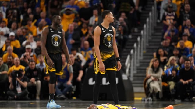 Los Angeles Lakers guard Dennis Schroder (17) lays on the ground after being fouled by Golden State Warriors guard Jordan Poole (3) in the fourth quarter during game one of the 2023 NBA playoffs at the Chase Center.