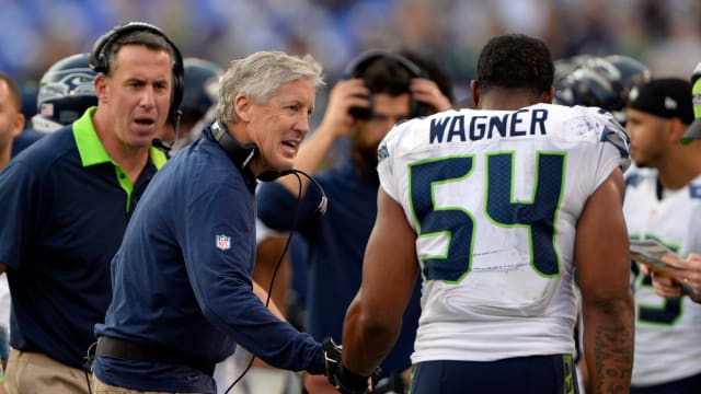 Seattle Seahawks head coach Pete Carroll talks to middle linebacker Bobby Wagner (54) after they stopped Baltimore Ravens on fourth down during the second half at M&T Bank Stadium. Seattle Seahawks defeated Baltimore Ravens 35-6.