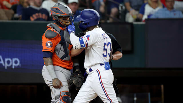 Oct 20, 2023; Arlington, Texas, USA; Texas Rangers right fielder Adolis Garcia (53) confronts Houston Astros catcher Martin Maldonado (15) after being hit by a pitch during the eighth inning of game five in the ALCS for the 2023 MLB playoffs at Globe Life Field. Mandatory Credit: Kevin Jairaj-USA TODAY Sports