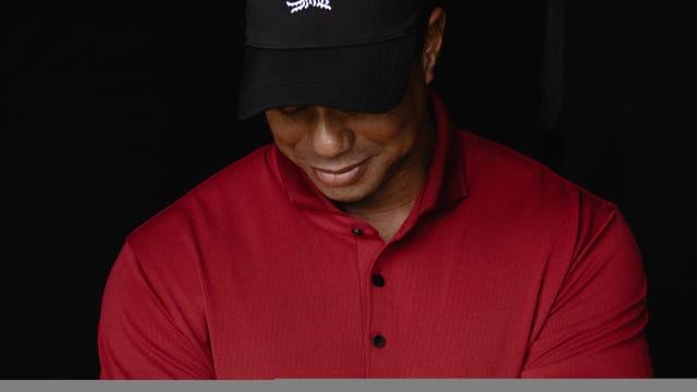 Tiger Woods models a red Sun Day Red shirt.