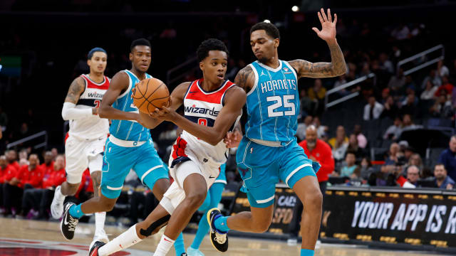 Washington Wizards guard Bilal Coulibaly (0) drives to the basket as Charlotte Hornets forward P.J. Washington (25) defends in the third quarter at Capital One Arena.