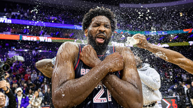 Philadelphia 76ers players pour water on Joel Embiid after he scored 70 points.
