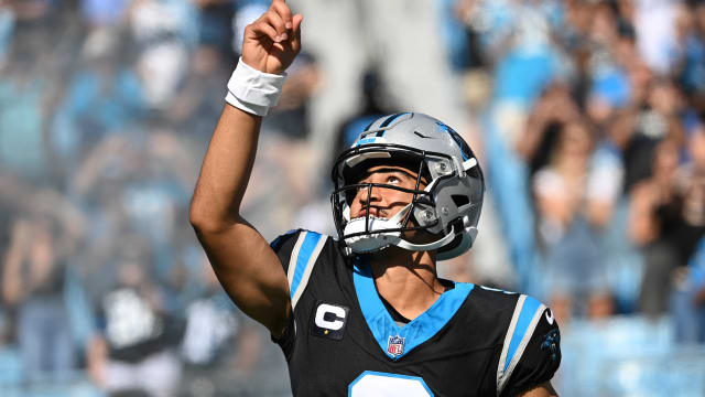 Carolina Panthers quarterback Bryce Young runs onto the field before a game.
