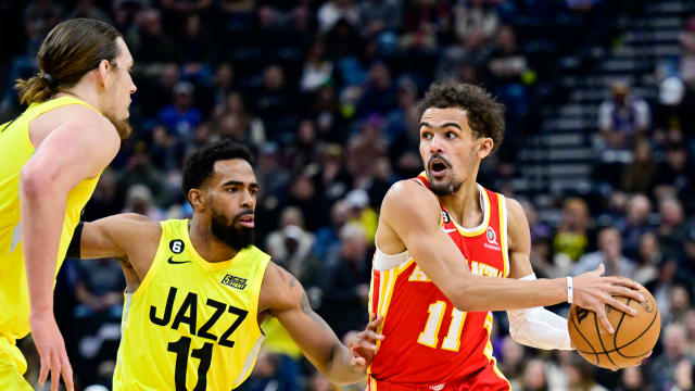 Hawks guard Trae Young dribbles around Jazz guard Mike Conley and center Kelly Olynyk.